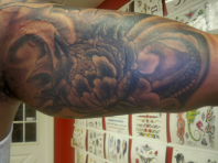 Upper arm tattoo artist floral